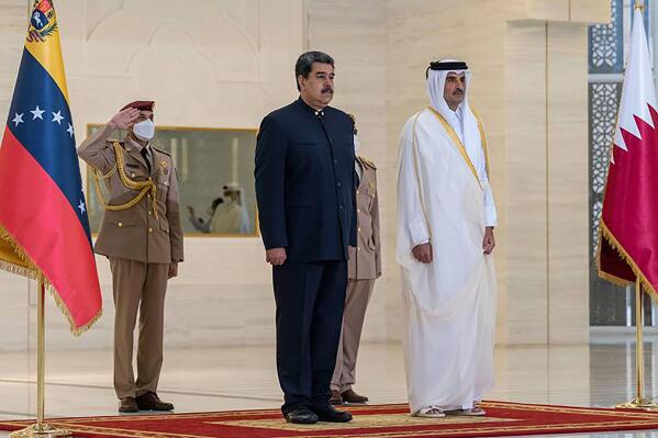 In this photo released by Qatar News Agency, QNA, Qatari Emir Sheikh Tamim bin Hamad Al-Thani, right, receives Venezuela's President Nicolas Maduro in Doha, Qatar, Wednesday, June 15, 2022. (QNA via AP)