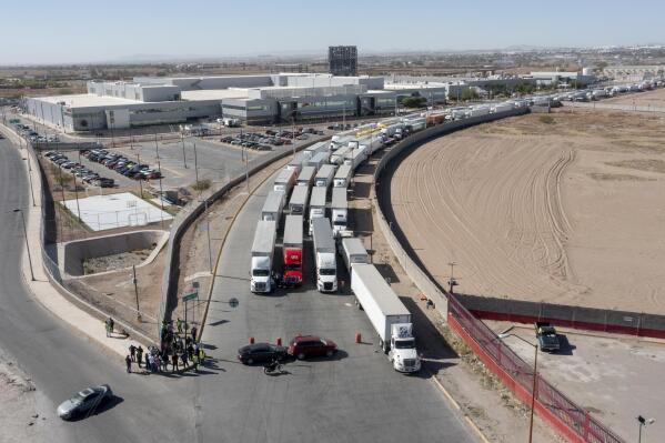 A long line of trucks is seeing stalled at the Zaragoza International Bridge, one of two ports of entry in Ciudad Juarez going into the U.S.on April 12, 2022. The truckers blocked both north and south bound commercial lanes in protest after they have seen prolonged processing times implemented by Gov. Abbott which they say have increased from 2-3 hours up to 14 hours in the last few days. (Omar Ornelas /The El Paso Times via AP)