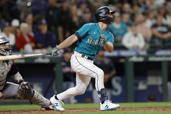 Seattle Mariners' Adam Frazier hits a sacrifice fly scoring Eugenio Suarez against the Cleveland Guardians during the seventh inning of a baseball game, Friday, Aug. 26, 2022, in Seattle. (AP Photo/John Froschauer)