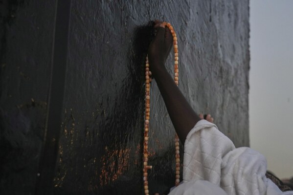 Muslim pilgrims offer prayers at top of the rocky hill known as the Mountain of Mercy, on the Plain of Arafat, during the annual Hajj pilgrimage near the holy city of Mecca, Saudi Arabia, Thursday, June 5, 2025. (AP Photo/Amr Nabil)