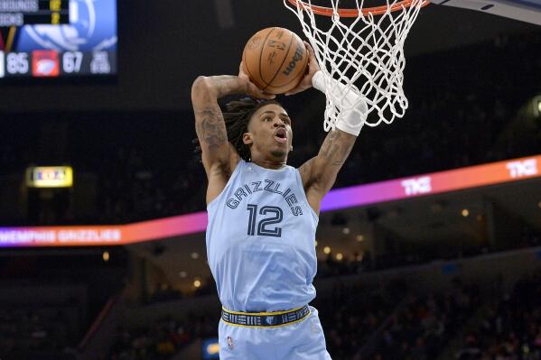 Memphis Grizzlies guard Ja Morant goes up for a dunk during the second half of the team's NBA basketball game against the New Orleans Pelicans on Tuesday, March 8, 2022, in Memphis, Tenn. (AP Photo/Brandon Dill)