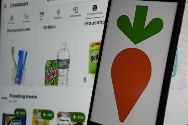 An instacart logo and an instacart webpage are shown in this photo, in New York, Wednesday, Sept. 6, 2023. (AP Photo/Richard Drew)