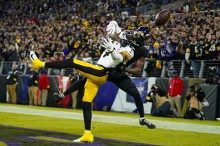 Baltimore Ravens cornerback Brandon Stephens (21) breaks up a pass to Pittsburgh Steelers wide receiver George Pickens (14) in the first half of an NFL football game in Baltimore, Sunday, Jan. 1, 2023. (AP Photo/Julio Cortez)