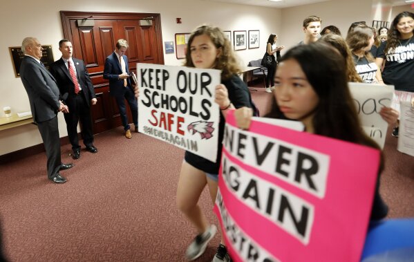 
              Student survivors from Marjory Stoneman Douglas High School, where moe than a dozen students and faculty were killed in a mass shooting on Wednesday, walk past the house legislative committee rom, to talk to legislators at the state Capitol, regarding gun control legislation, in Tallahassee, Fla., Wednesday, Feb. 21, 2018. (AP Photo/Gerald Herbert)
            