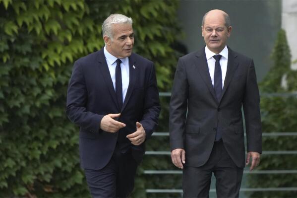 German Chancellor Olaf Scholz, right, and Israeli Prime Minister Yair Lapid, left, arrive for a joint press conference as part of a meeting at the chancellery in Berlin, Germany, Monday, Sept. 12, 2022. (AP Photo/Michael Sohn)