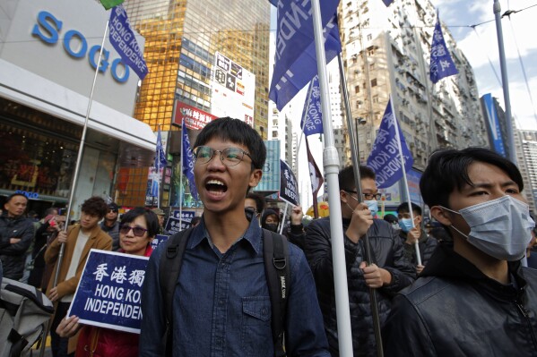 FILE - Pro-independence demonstrator Tony Chung, left, marches during an annual New Year protest in Hong Kong on Jan. 1, 2019. Chung, who advocated for Hong Kong independence and was jailed under a sweeping national security law fled to Britain to seek political asylum, according to his social media posts Friday, Dec. 29, 2023. (AP Photo/Kin Cheung, File)