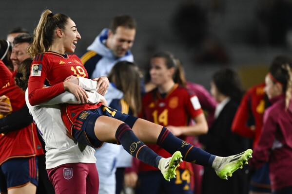 Spain's Olga Carmona is held aloft by a teammate after defeating Sweden in the Women's World Cup semifinal soccer match at Eden Park in Auckland, New Zealand, Tuesday, Aug. 15, 2023. (AP Photo/Andrew Cornaga)