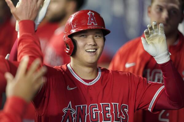 FILE - Los Angeles Angels' Shohei Ohtani is greeted in the dugout after he hit a solo home run during the first inning of a baseball game against the Seattle Mariners, Sunday, Oct. 3, 2021, in Seattle. Ohtani, the Los Angeles Angels’ two-way superstar, is the winner of The Associated Press’ Male Athlete of the Year award. (AP Photo/Ted S. Warren, File)