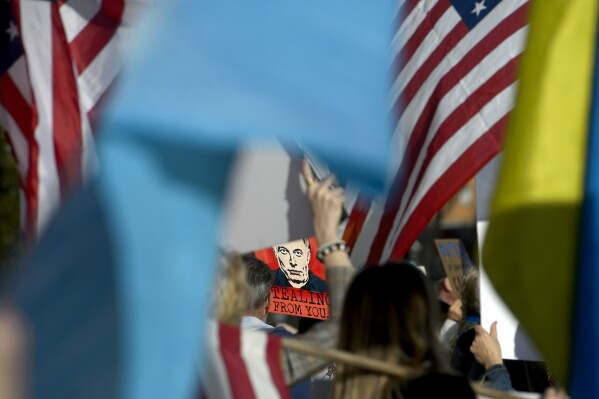 Demonstrators protest across the street from the Capitol in the hours prior to President Donald Trump's address to a joint session of Congress at the Capitol, Tuesday, March 4, 2025, in Washington. (AP Photo/Rod Lamkey, Jr.)