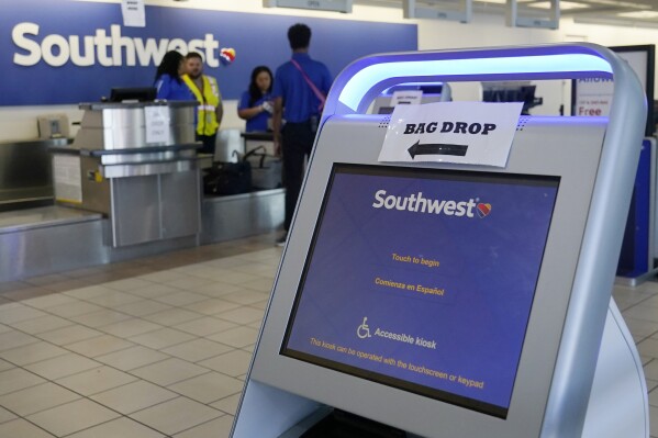 FILE - Employees stand by an empty Southwest Airlines ticket counter Tuesday, April 18, 2023, in Oklahoma City. Southwest Airlines reports earnings on Thursday, Oct. 26, 2023 (AP Photo/Sue Ogrocki, File)