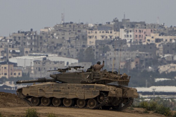 An Israeli soldier on top a tank on the border with the Gaza Strip, in southern Israel, Sunday, Sunday, March 17, 2024. (AP Photo/Ariel Schalit)