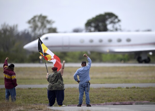 Supporters react as a plane carrying Leonard Peltier takes off from Leesburg International Airport, Tuesday, Feb. 18, 2025, in Leesburg, Fla. (AP Photo/Phelan M. Ebenhack)