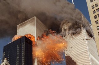 FILE - In this Sept. 11, 2001, file photo, smoke billows from one of the towers of the World Trade Center and flames as debris explodes from the second tower in New York. Family members of 9/11 families and others harmed in the terrorist attacks are on a fresh quest to hold Saudi Arabia responsible. A magistrate judge presiding over a Thursday, March 23, 2017, hearing says she hopes to streamline the legal process to speed the lawsuits along. (AP Photo/Chao Soi Cheong, File)