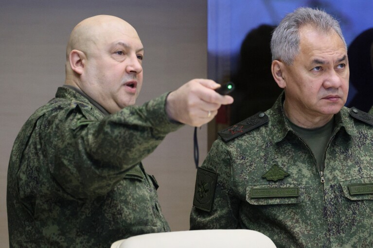 FILE - The top Russian military commander in Ukraine, Gen. Sergei Surovikin, left, and Russian Defense Minister Sergei Shoigu, center, attend a meeting with President Vladimir Putin during a visit to troops at an unknown location on Saturday, Dec. 17, 2022. (Gavriil Grigorov, Sputnik, Kremlin Pool Photo via AP, File)