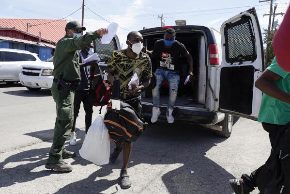 Migrants are released from United States Border Patrol custody at a humanitarian center, Wednesday, Sept. 22, 2021, in Del Rio, Texas. (AP Photo/Julio Cortez)