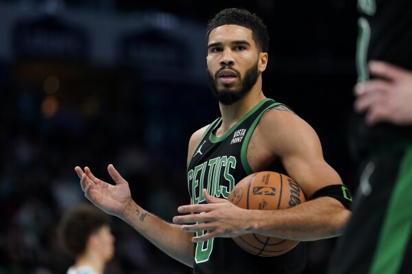 Boston Celtics forward Jayson Tatum reacts after a play in the first half of an NBA basketball game against the Charlotte Hornets, Monday, Nov. 20, 2023, in Charlotte, N.C. (AP Photo/Erik Verduzco)