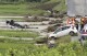 A police vehicle is seen overturned following a heavy rain in Shinjo, Yamagata prefecture, northern Japan Friday, July 26, 2024. Heavy rain hit northern Japan Thursday, triggering floods and landslides, disrupting transportation systems and forcing hundreds of residents to take shelter at safer grounds. (Kyodo News via ĢӰԺ)