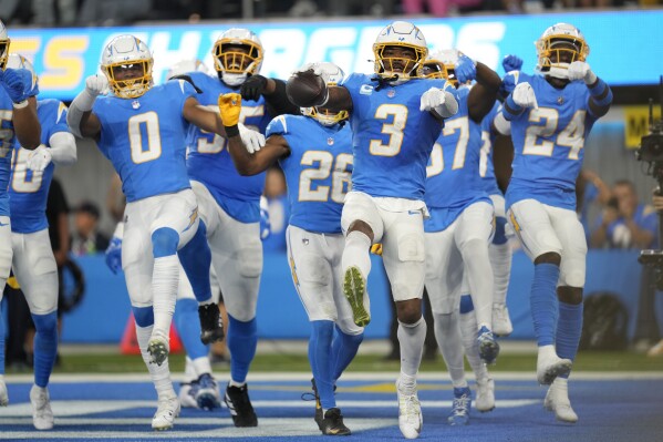 Los Angeles Chargers safety Derwin James Jr. (3) celebrates his interception with teammates during the second half of an NFL football game against the Chicago Bears, Sunday, Oct. 29, 2023, in Inglewood, Calif. (AP Photo/Ashley Landis)