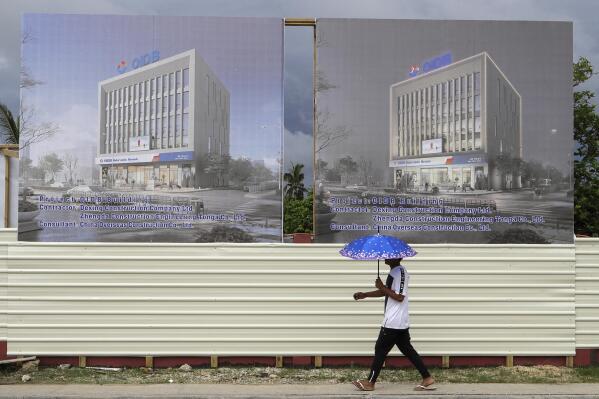 FILE - A man walks past a development site for a Chinese Investment bank in Nuku'alofa, Tonga, April 10, 2019. Beijing was targeting its Pacific aid to new diplomatic allies Solomon Islands and Kiribati while Chinese financial support across the region continued to decline, the Lowy Institute has reported, Monday, Oct. 31, 2022, in its latest annual analysis of regional aid. (AP Photo/Mark Baker, File)