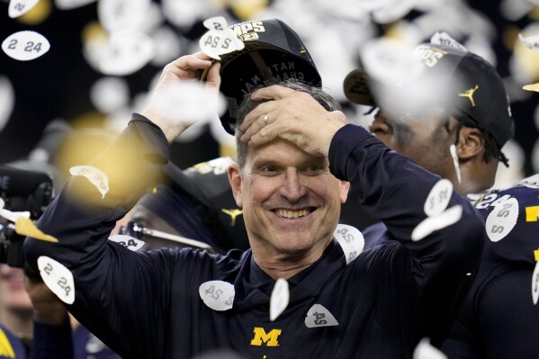 FILE - Michigan coach Jim Harbaugh celebrates the team's win in the national championship NCAA college football playoff game against Washington, Jan. 8, 2024, in Houston. Harbaugh will be the coach of the Los Angeles Chargers, leaving Michigan after capping his ninth season as coach of college football’s winningest program with the school’s first national championship since 1997, two people familiar with the situation told The Associated Press. The people spoke to the AP on condition of anonymity because the team hasn’t made the announcement. (AP Photo/Godofredo A. Vasquez, File)
