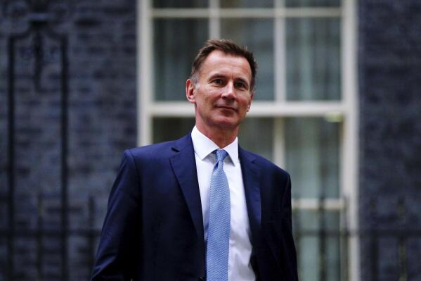 Jeremy Hunt leaves 10 Downing Street in London after he was appointed Chancellor of the Exchequer following the resignation of Kwasi Kwarteng, Friday Oct. 14, 2022. Chancellor of the Exchequer Kwasi Kwarteng said he has accepted Prime Minister Liz Truss' request he "stand aside" as Chancellor, paying the price for the chaos unleashed by his mini-budget. (Victoria Jones/PA via AP)