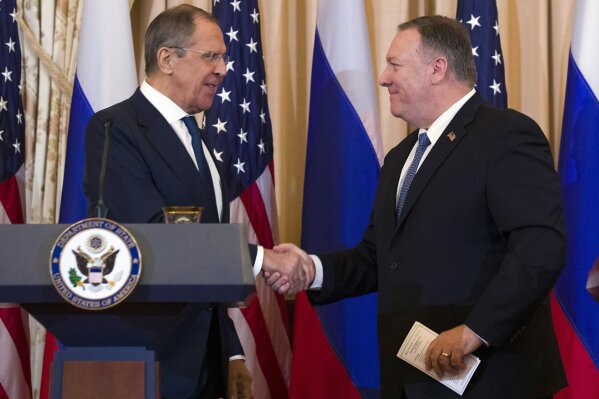 Secretary of State Mike Pompeo, right, shake hands with Russian Foreign Minister Sergey Lavrov, after a media availability at the State Department, Tuesday, Dec. 10, 2019, in Washington. (AP Photo/Alex Brandon)