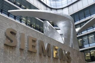 FILE - This Thursday, Nov. 9, 2017 file photo shows the logo of German industrial conglomerate Siemens in front of their headquarters in Munich, Germany. Siemens ignored some of its own red flags for foreign bribery in the aftermath of a major corruption scandal in 2008, according to reports released in 2021 by an independent monitor and other confidential documents. (AP Photo/Matthias Schrader, File)