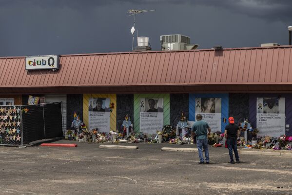 FILE - People visit a memorial outside Club Q, an LGBTQ nightclub, which was the site of a deadly 2022 shooting that left five people dead in Colorado Springs, Colo., on June 7, 2023.  The shooter who was sentenced to life in prison for killing five clubbers in Colorado Springs was charged with a federal hate crime and weapons violation on Tuesday, Jan. 16, 2024.  (AP Photo/Chet Strange, File)