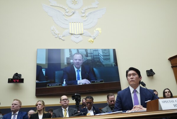 Department of Justice Special Counsel Robert Hur listens during a House Judiciary Committee hearing, Tuesday March 12, 2024, on Capitol Hill in Washington. Rep. Adam Schiff, D-Calif., in shown on the video screen behind. (AP Photo/Jacquelyn Martin)