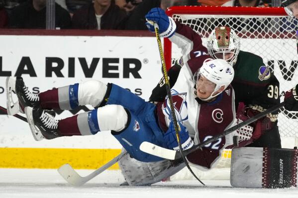 Colorado Avalanche left wing Artturi Lehkonen (62) collides with Arizona Coyotes goaltender Connor Ingram (39) during the third period of an NHL hockey game in Tempe, Ariz., Tuesday, Dec. 27, 2022. The Coyotes won 6-3. (AP Photo/Ross D. Franklin)