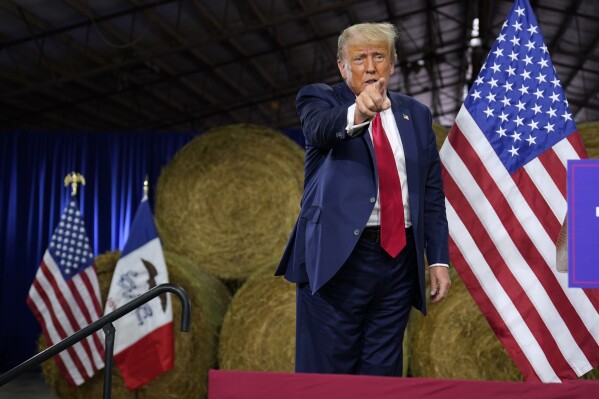 Former President Donald Trump reacts after a commit to caucus rally, Monday, Oct. 16, 2023, in Adel, Iowa. Donald Trump’s political fundraising machine is raking in donations at a prodigious pace, but he’s spending tens of millions of dollars he’s bringing in to pay attorneys to deal with the escalating costs of the various criminal cases he is contending with.(AP Photo/Charlie Neibergall)