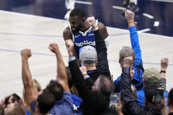 Fans celebrate after Dallas Mavericks forward Tim Hardaway Jr., center, sunk a three-point shot in the second half of an NBA basketball game against the Golden State Warriors in Dallas, Tuesday, Nov. 29, 2022. (AP Photo/Tony Gutierrez)