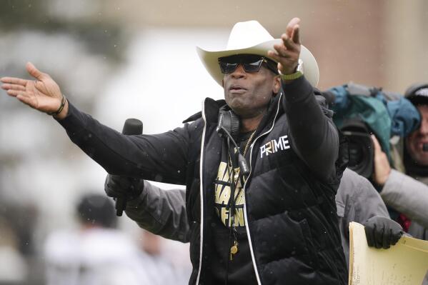 Colorado head coach Deion Sanders plays to the fans in the first half of the team's spring practice NCAA college football game Saturday, April 22, 2023, in Boulder, Colo. (AP Photo/David Zalubowski)