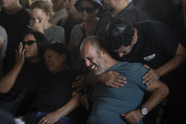 Mourners attend the funeral of the Israeli woman Shiraz Tamam, killed by Hamas militants while attending a music festival, at a cemetery in Holon, central Israel, Tuesday, Oct. 17, 2023. (AP Photo/Petros Giannakouris