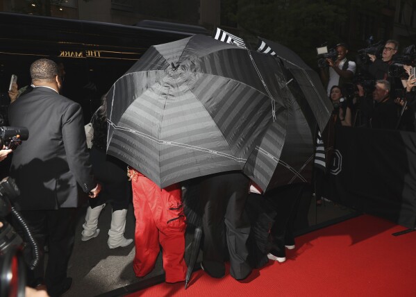 Umbrellas cover a person as they depart The Mark Hotel prior to attending The Metropolitan Museum of Art's Costume Institute benefit gala celebrating the opening of "Sleeping Beauties: Reawakening Fashion" on Monday, May 6, 2024, in New York. (Photo by CJ Rivera/Invision/AP)