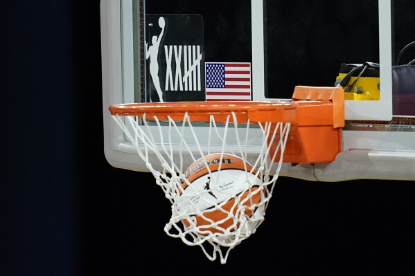 FILE - A logo on the backboard marks the 25th anniversary of the WNBA as the Los Angeles Sparks warm up before a WBNA basketball game against the Dallas Wings Friday, May 14, 2021, in Los Angeles. The WNBA franchise that's affiliated with the Golden State Warriors, the Golden State Valkyries, unveiled the team's brand identity, Tuesday, May 14, 2024, with the name and logo. (AP Photo/Ashley Landis, File)