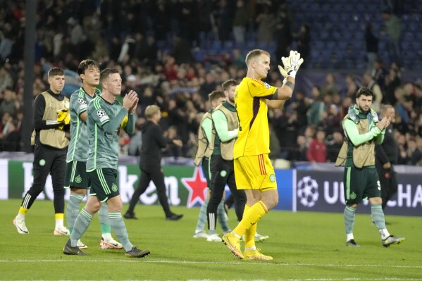 Celtic's goalkeeper Joe Hart, center, and teammates after losting their Champions League Group E soccer match between Feyenoord and Celtic at the Kuip stadium in Rotterdam, Netherlands, Tuesday, Sept. 19, 2023. (AP Photo/Peter Dejong)