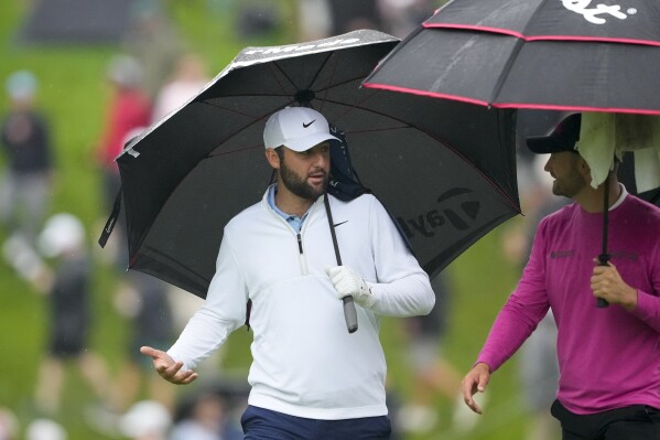 Scottie Scheffler talks with Wyndham Clark on the 10th hole during the second round of the PGA Championship golf tournament at the Valhalla Golf Club, Friday, May 17, 2024, in Louisville, Ky. (AP Photo/Matt York)