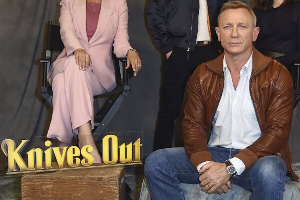FILE - Daniel Craig attends the "Knives Out" photo call on Nov. 15, 2019, in Los Angeles. Netflix said Wednesday, March 31, 2021, it has reached a deal for two sequels to Rian Johnson's acclaimed 2019 whodunit, "Knives Out." Johnson will direct with Daniel Craig returning as inspector Benoit Blanc. (Photo by Jordan Strauss/Invision/AP, File)