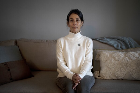 Rachel Goldberg poses for a portrait on day 98 since her son, Hersh Goldgerg-Polin was kidnapped by Hamas, in Jerusalem, Friday, Jan. 12, 2024. Every morning, before she's even out of her pajamas, she tears a piece of masking tape off the roll, grabs a marking pen and in thick black strokes writes down the number of days her son, Hersh, has been held hostage by Hamas militants. Then she sticks it to her chest. (AP Photo/Maya Alleruzzo)