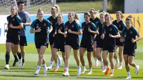 From left, players Melanie Leupholz, Sarai Linder, Lena Lattwein, Svenja Hut, Laura Freigang, Sara Doorsoun, Carolin Simon, Sophia Kleinherne, Chantal Hagel and Felicitas Rauch warm up during training session of the German women's national soccer team in Herzogenaurach, Germany, Monday, June 3, 2023. The women's soccer world championships take place in Australia and New Zealand from July 20, 2023 until August 20, 2023. (Daniel Loeb/dpa/dpa via AP)