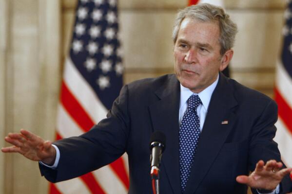 FILE - U.S. President George W. Bush, reacts, after shoes were thrown at him, by a correspondent, during a joint press conference with Iraq Prime Minister Nouri al-Maliki, not seen, in Baghdad, Iraq, Dec. 14, 2008.  Bush is facing criticism after mistakenly describing the invasion of Iraq — which he led as commander in chief — as “brutal” and “wholly unjustified,” before correcting himself to say he meant to refer to Russia’s invasion of Ukraine. He added, “Iraq, too — anyway.” The 75-year-old former president made the comment during a speech Wednesday night in Dallas, jokingly blamed the mistake on his age.  (AP Photo/ Thaier al-Sudani, Pool, File)