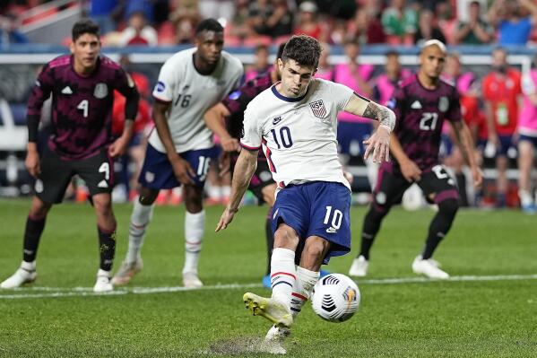 FILE - In this June 6, 2021, file photo, United States' Christian Pulisic (10) kicks a penalty kick for a goal against Mexico during extra time in the CONCACAF Nations League championship soccer match in Denver. Pulisic's availability for the United States' opening World Cup qualifier remains unclear following his positive COVID test. The top American player was on the 26-man roster announced Thursday for the first three qualifiers after missing Chelsea’s match at Arsenal last weekend. The U.S. starts at El Salvador on Sept. 2. (AP Photo/Jack Dempsey, File)
