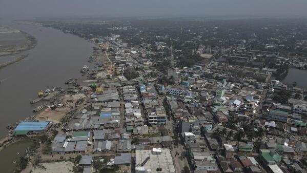 An aerial view shows Mongla town in Bangladesh, March 3, 2022. This town was once vulnerable to floods and river erosion, but now it has become more resilient with improved infrastructure against high tides and erosion. Bangladesh's second-largest seaport is located in Mongla. Recent investment in an export processing zone that houses factories has created new opportunities for the climate migrants who have lost their homes, land and livelihood due to impacts of climate change. (AP Photo/Mahmud Hossain Opu)