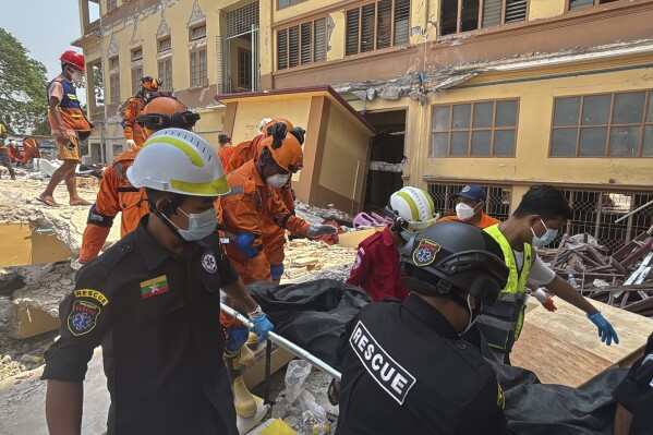 Indian and Myanmar rescuers carry a dead body at U Hla Thein Buddhist monastery that collapsed in Friday's earthquake in Mandalay, Myanmar, Monday, March 31, 2025. (AP Photo)