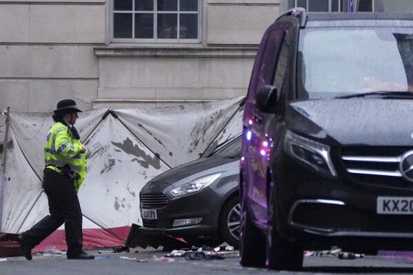 Police and emergency personnel deal with an incident near the Liver Building during the Premier League winners parade in Liverpool, England, Monday, May 26, 2025.(AP Photo/Jon Super)