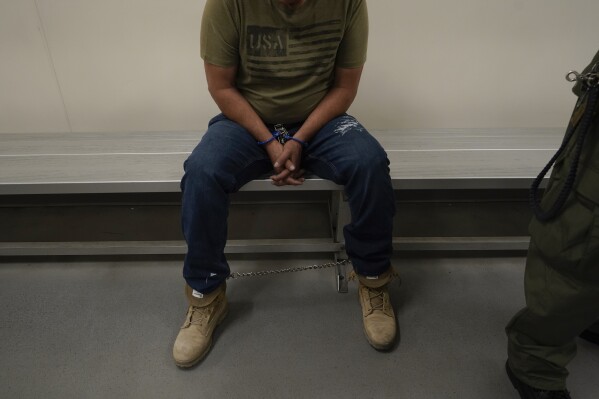 FILE - An immigrant considered a threat to public safety and national security waits to be processed by U.S. Immigration and Customs Enforcement agents at the ICE Metropolitan Detention Center in Los Angeles, after an early morning raid, June 6, 2022. The Supreme Court said Friday, June 23, 2023, that it will no longer stand in the way of a long-blocked Biden administration policy to prioritize the deportation of immigrants who are deemed to pose the greatest public safety risk or were picked up at the border. (AP Photo/Damian Dovarganes, File)