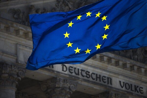 FILE - A European flag waves in front of the Reichstag building with the inscription 'Dem deutschen Volke' ('To The German People') in Berlin, Germany, Thursday, Aug. 23, 2012. German politics are in a disgruntled, volatile state as the country's voters prepare to fill 96 of the 720 seats at the European Parliament on June 9, the biggest single national contingent in the 27-nation European Union. It's the first nationwide vote since center-left Chancellor Olaf Scholz took power in late 2021. (AP Photo/Markus Schreiber, File)