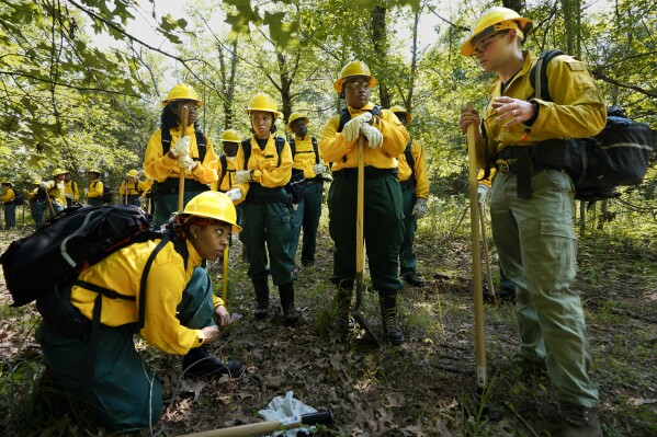 Students listen to instruction from instructor Ben McLane, right, during a wildland firefighter training, June 9, 2023, in Hazel Green, Ala. (AP Photo/George Walker IV, File)