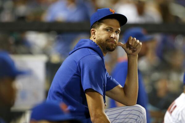 New York Mets pitcher Jacob deGrom watches play against the Los Angeles Dodgers during the seventh inning of a baseball game Saturday, Aug. 14, 2021, in New York. (AP Photo/Noah K. Murray)
